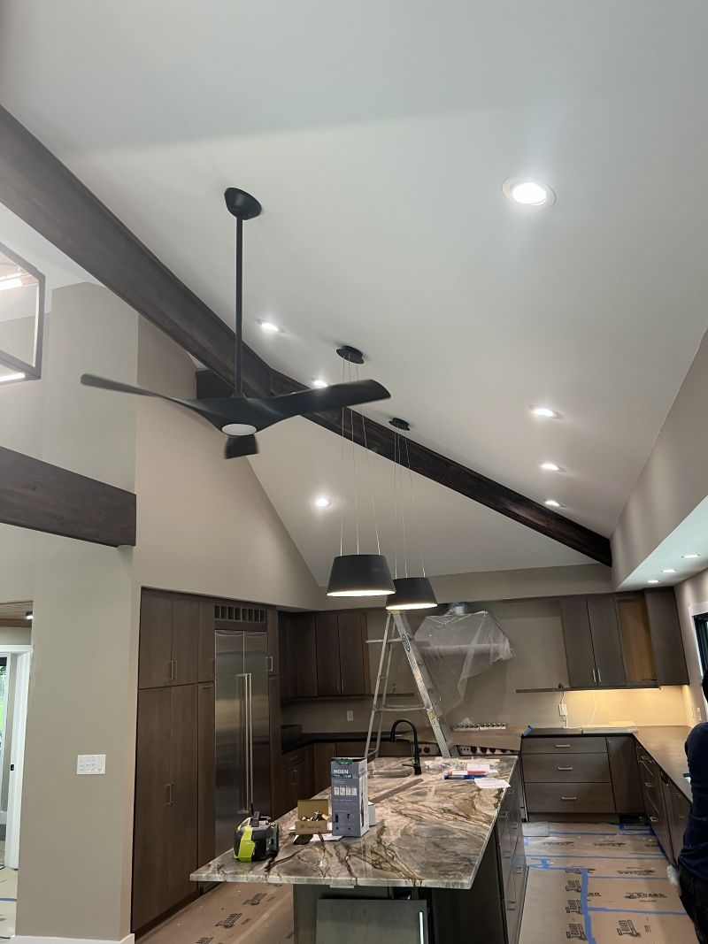 Vaulted kitchen ceiling with a wood beam, recessed lights and a ceiling fan